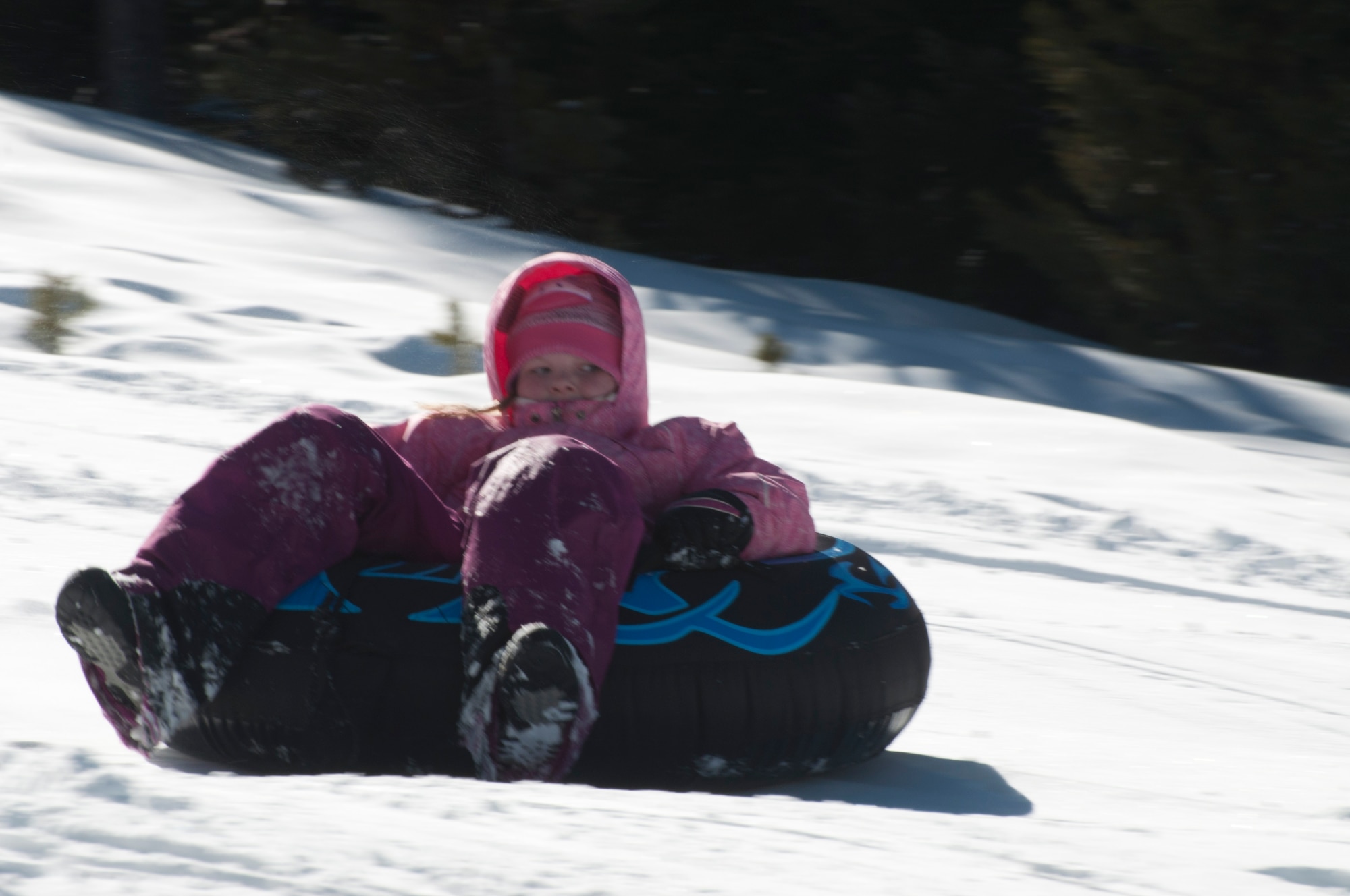 140308-F-GZ967-038 Felicity Sakura, 8, daughter of Captain Eydie Sakura, rides an inflated, inner-tube March 8 during an Outdoor Recreation snow tubing trip. Outdoor Rec. hosts a variety of adventures each month for Airmen and families alike – including snowboarding trips, indoor skydiving and Disney on Ice. (U.S. Air Force photo by Airman 1st Class Brandon Valle)