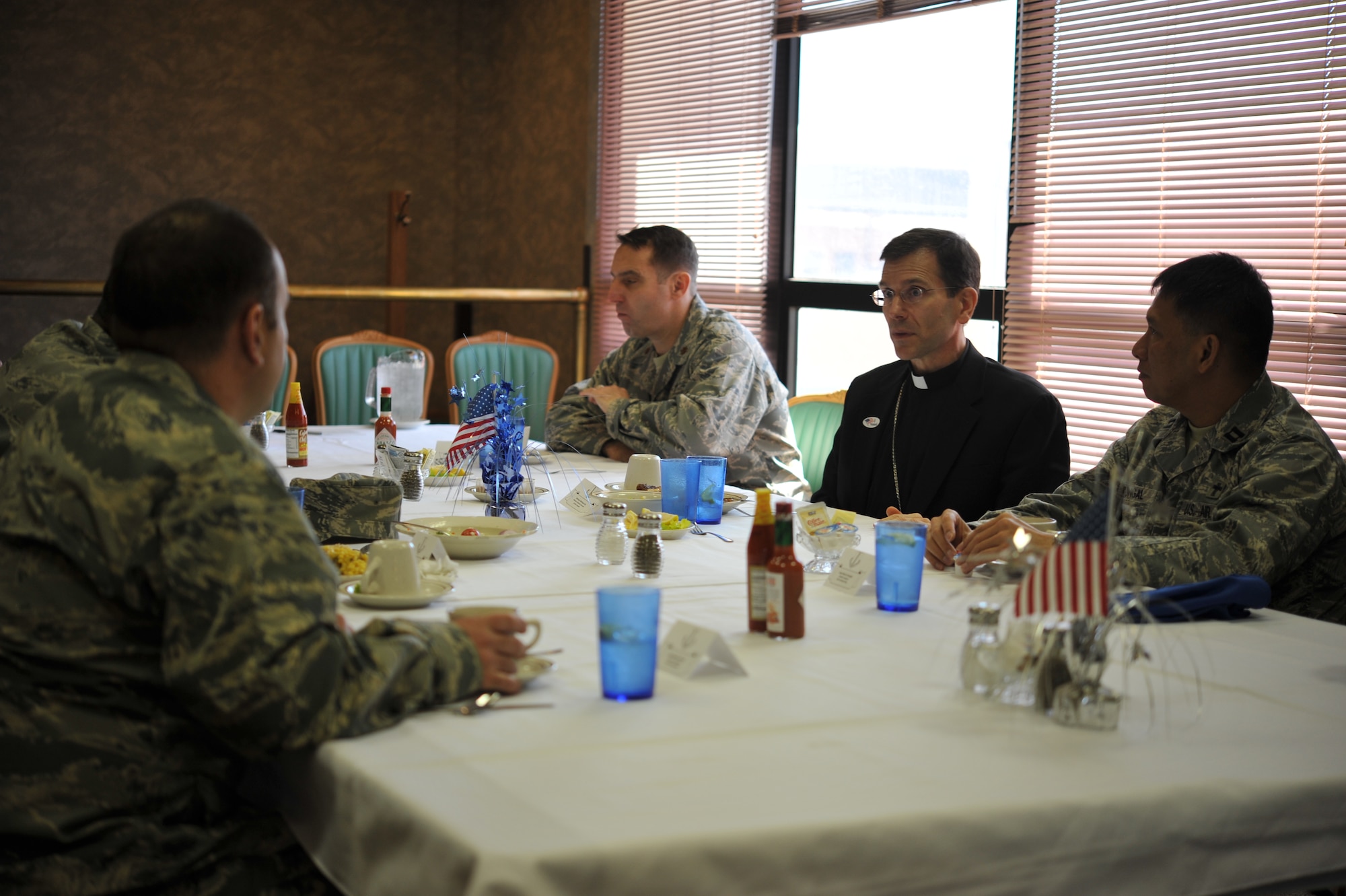 GOODFELLOW AIR FORCE BASE, Texas-- Bishop Michael Sis, Roman Catholic Diocese of San Angelo, center, visits with Team Goodfellow members at Western Winds dining facility here Feb. 28. Sis toured the base and visited with Team Goodfellow members to strengthen the relationship between the Catholic Diocese of San Angelo and Goodfellow. (U.S. Air Force photo/ Airman 1st Class Michael Smith)