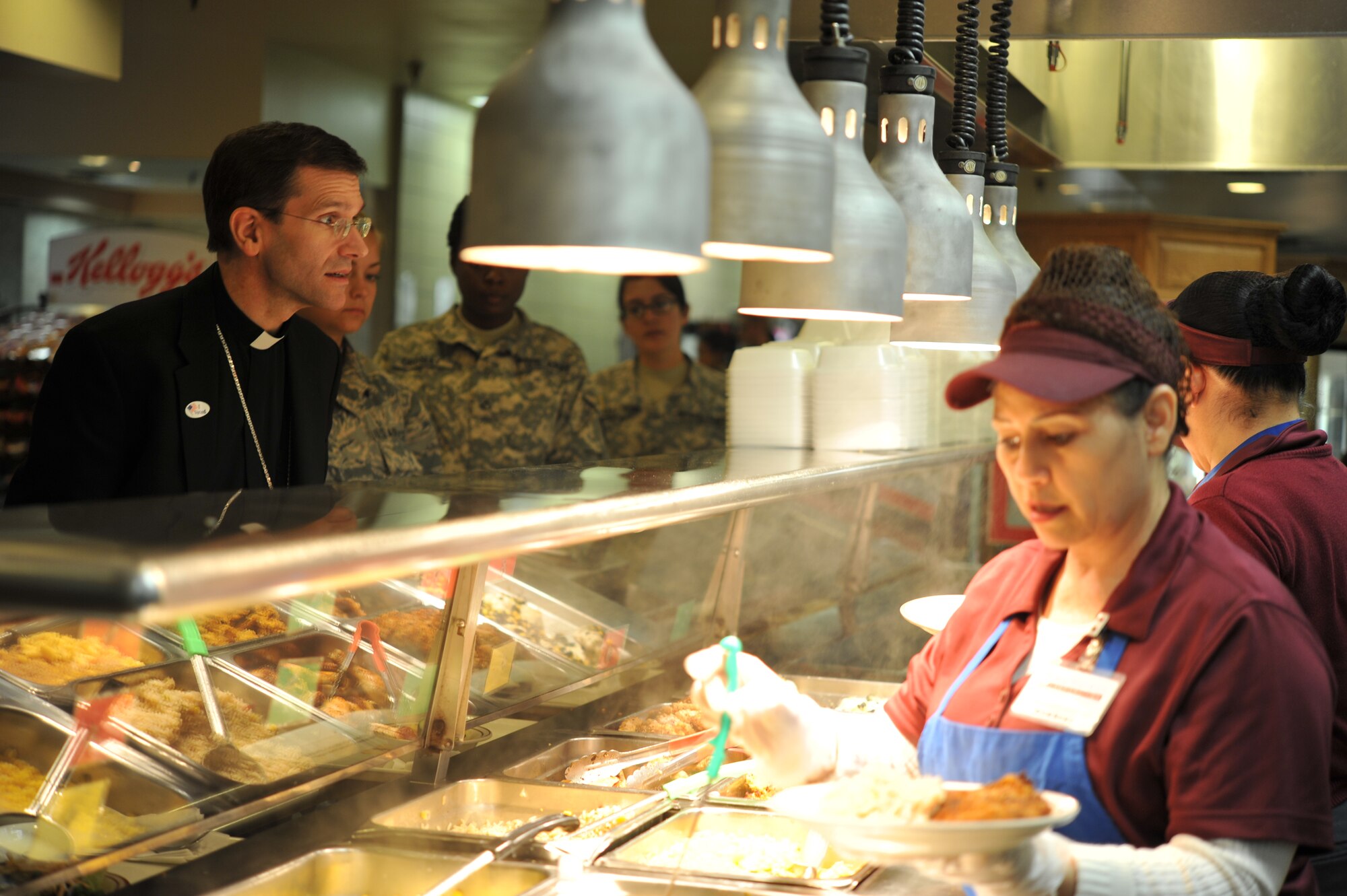 GOODFELLOW AIR FORCE BASE, Texas-- Bishop Michael Sis, Roman Catholic Diocese of San Angelo, asks for food at the Western Winds dining facility during a tour of Goodfellow here Feb. 28. Sis was appointed the sixth bishop of San Angelo, Texas, Dec. 12, 2013, after serving as the vicar-general and the moderator of the curia for the diocese of Austin since 2010. (U.S. Air Force photo/ Airman 1st Class Michael Smith)