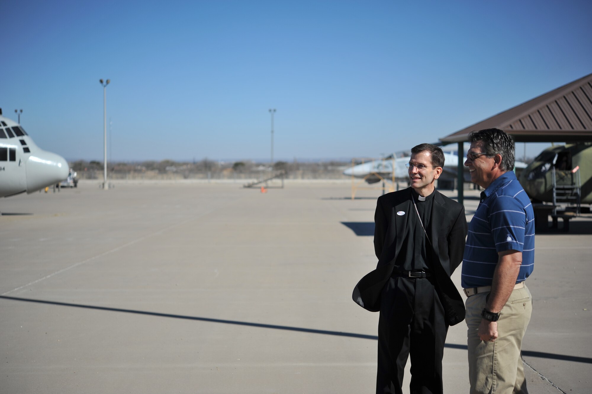 GOODFELLOW AIR FORCE BASE, Texas-- Bishop Michael Sis, Roman Catholic Diocese of San Angelo, left, talks with Michael Dejacomo, 312th Training Squadron fire training instructor, during a tour of the Louis F. Garland DOD Fire Academy here Feb. 28. Sis was invited out to Goodfellow to learn about the wing’s mission and its members. (U.S. Air Force photo/ Airman 1st Class Michael Smith)