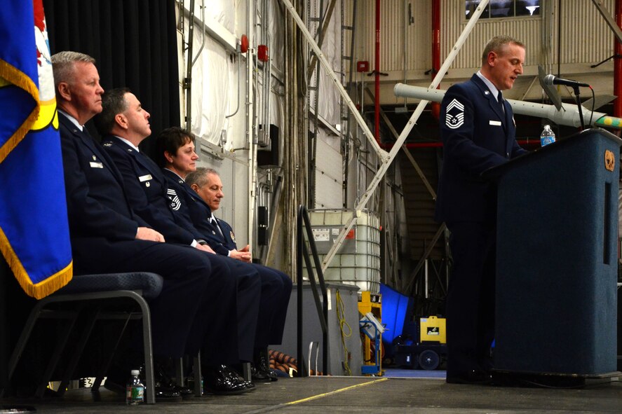 PEASE AIR NATIONAL GUARD BASE, N.H. -- Command Chief Master Sgt. Jamie Lawrence, 157th Air Refueling Wing, speaks at the podium after accepting the wing flag as the prinicipal enlisted advisor to Col. Paul Hutchinson, the 157th Air Refueling Wing commander, in Hanger 254 here, March 9, 2014. Lawrence replaces Chief Master Sgt. Brenda Blonigen who served in the position for more than five years. Lawrence previous role was as the 66th Force Support Squadron superintendent. (N.H. National Guard photo by Tech. Sgt. Mark Wyatt/RELEASED)