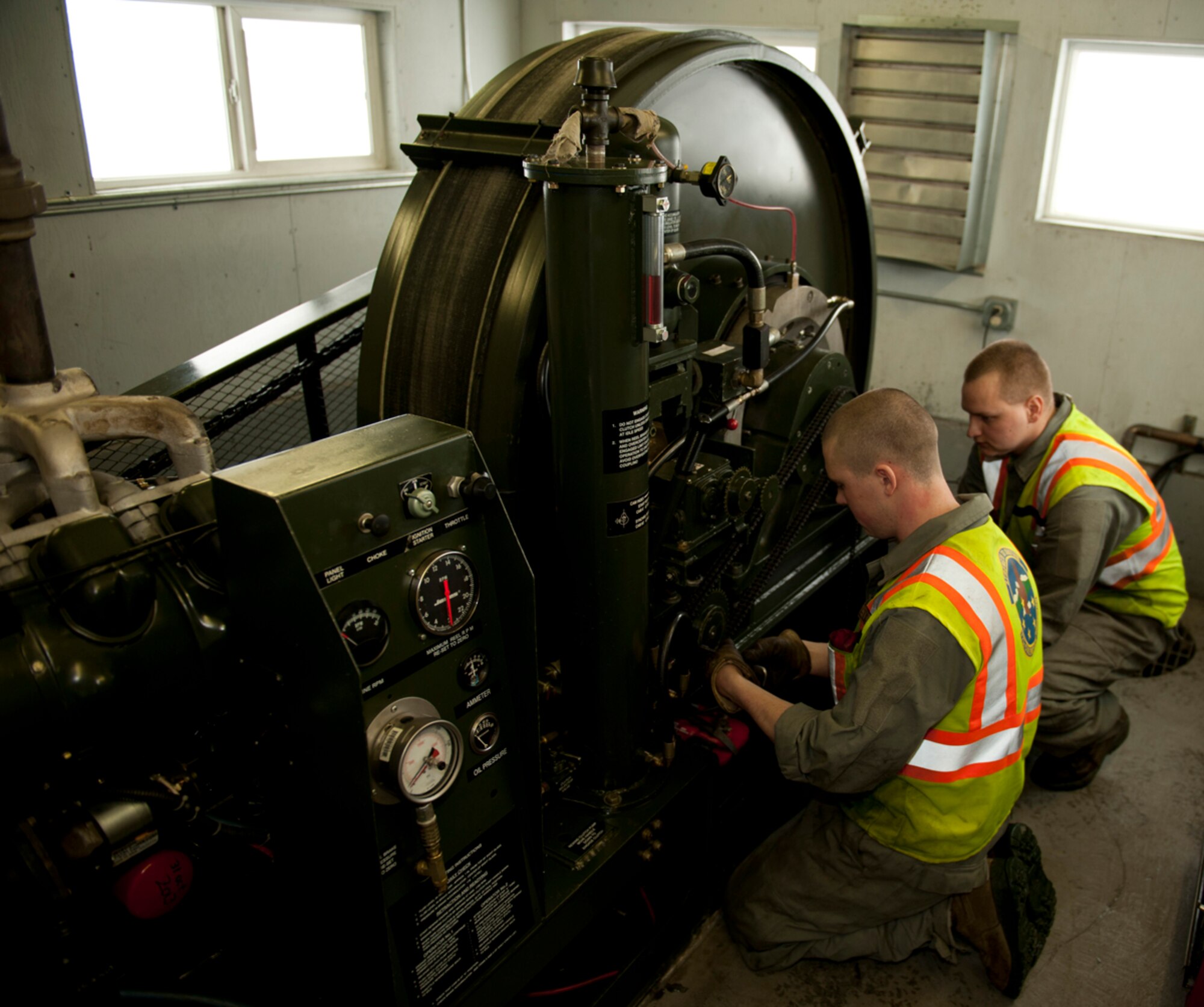 Airmen 1st Class Taylor McClellen and Shawn Chilcutt, 773d Civil Engineer Squadron power production maintainers, conduct routine maintenance on a Barrier Arresting Kit-12 on Joint Base Elmendorf-Richardson, March 5. Maintainers conduct routine maintenance on barriers daily for in-flight emergencies to safely slow aircraft on the runway in an emergency. McClellen is a native of Chehalis, Wash., and Chilcutt is a native of Eaton Rapids, Mich. (U.S. Air Force photo/Airman 1st Class Tammie Ramsouer)