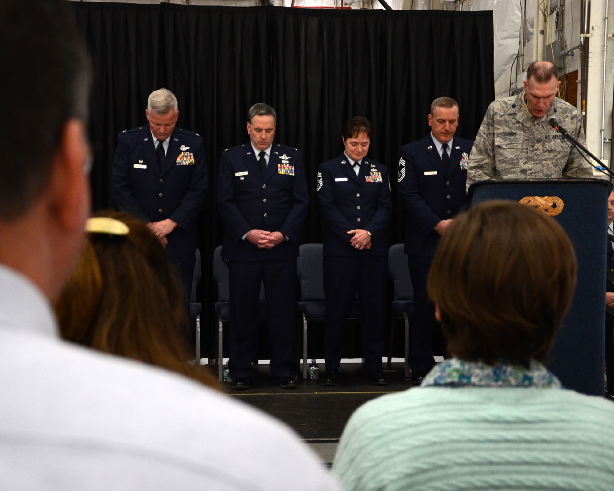 PEASE AIR NATIONAL GUARD BASE, N.H. -- Chaplain Robert J. Cordery delivers the invocation during the 157th Air Refueling Wing Change of Authority Ceremony in Hanger 254 as (left to right) Col. Paul Hutchinson, 157th Air Refueling Wing commander; Col. Peter Sullivan, 157th Air Refueling Wing vice commander; Command Chief Master Sgt. Brenda Blonigen; and incoming Command Chief Master Sgt. Jamie Lawrence look on. Lawrence replaces Chief Master Sgt. Brenda Blonigen who served in the position for more than five years. Lawrence previous role was as the 66th Force Support Squadron superintendent. (N.H. National Guard photo by Tech. Sgt. Mark Wyatt/RELEASED)