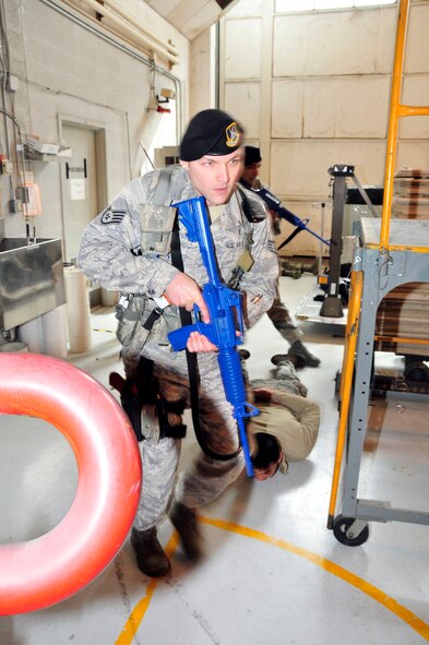 Staff Sgt. Scott Cavin, 134 ARW Security Forces Squadron Journeyman, races to mitigate the threat during an active shooter exercise on March 10 at McGhee Tyson Air National Guard Base, Tennessee.  The exercise included all personnel on base to better train them on what to do in an actual active shooter event.  (U.S. Air National Guard photo by Master Sgt. Kendra M. Owenby, 134 ARW Public Affairs)