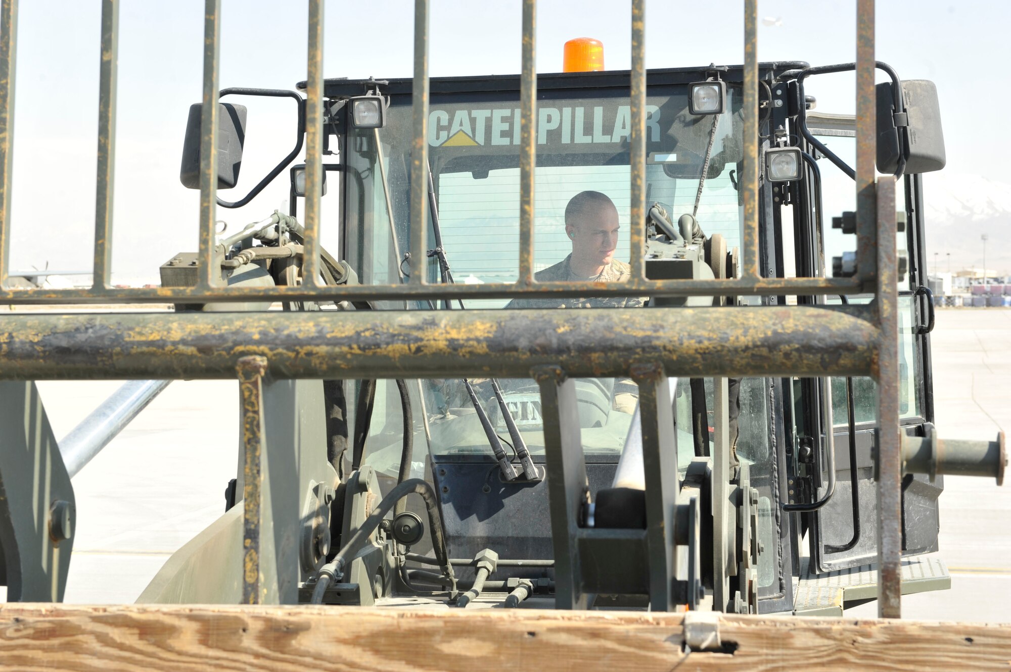 U.S. Air Force Airman 1st Class Gerald Mesick uses an all-terrain forklift to move cargo at Bagram Airfield, Afghanistan, Feb. 28, 2014. Mesick was deployed from the 109th Airlift Wing, New York Air National Guard, and worked on the ramp at Bagram.(U.S. Air Force photo by Senior Master Sgt. Gary J. Rihn/Released)