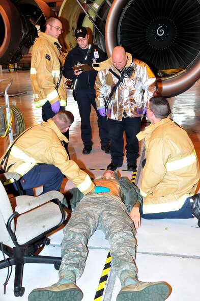 Firefighters from McGhee Tyson Air National Guard Base respond to render medical aid to a simulated wounded airman during an active shooter exercise on March 10.  (U.S. Air National Guard photo by Master Sgt. Kendra M. Owenby, 134 ARW Public Affairs)