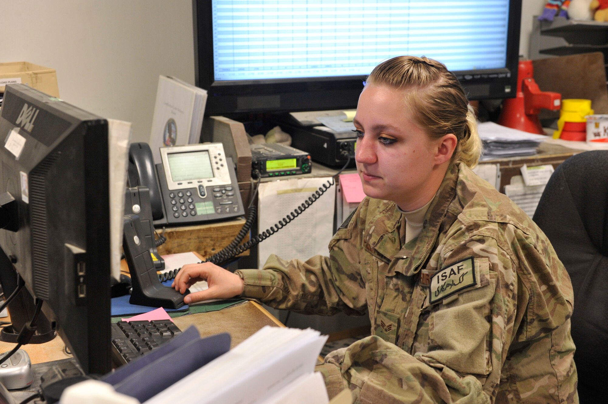 U.S. Air Force Senior Airman Brittany Foster assigns a crew via radio to download an inbound aircraft at Bagram Airfield, Afghanistan, Feb. 27, 2014. Foster was deployed from the 109th Airlift Wing, New York Air National Guard, and worked as a dispatcher at Bagram.(U.S. Air Force photo by Senior Master Sgt. Gary J. Rihn/Released)