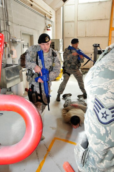 Security Forces Squadron airmen from the 134th Air Refueling Wing take the "suspect", Senior Airman Louis Mayor, into custody during a mock active shooter exercise on March 10 at McGhee Tyson Air National Guard Base, Tennessee.  The exercise included all personnel on base to better train them on what to do in an actual active shooter event.  (U.S. Air National Guard photo by Master Sgt. Kendra M. Owenby, 134 ARW Public Affairs)