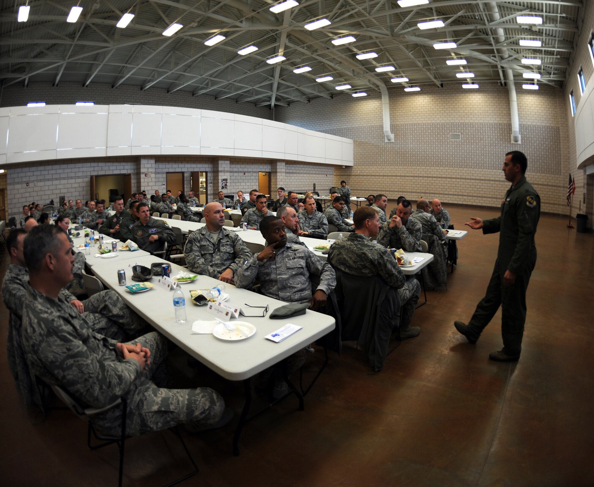 U.S. Air Force Capt. Jerad Rich, right, 9th Bomb Squadron, speaks to Airmen during the Air Force Assistance Fund kick-off luncheon March 3, 2014, at Dyess Air Force Base, Texas. The luncheon was organized to start the AFAF campaign and let Airmen know that key workers will be visiting their squadrons soon to provide knowledge of the charities, answer questions and assist with filling out the donation forms. This year’s campaign will run until April 11. (U.S. Air Force photo by Airman 1st Class Kedesha Pennant/Released)