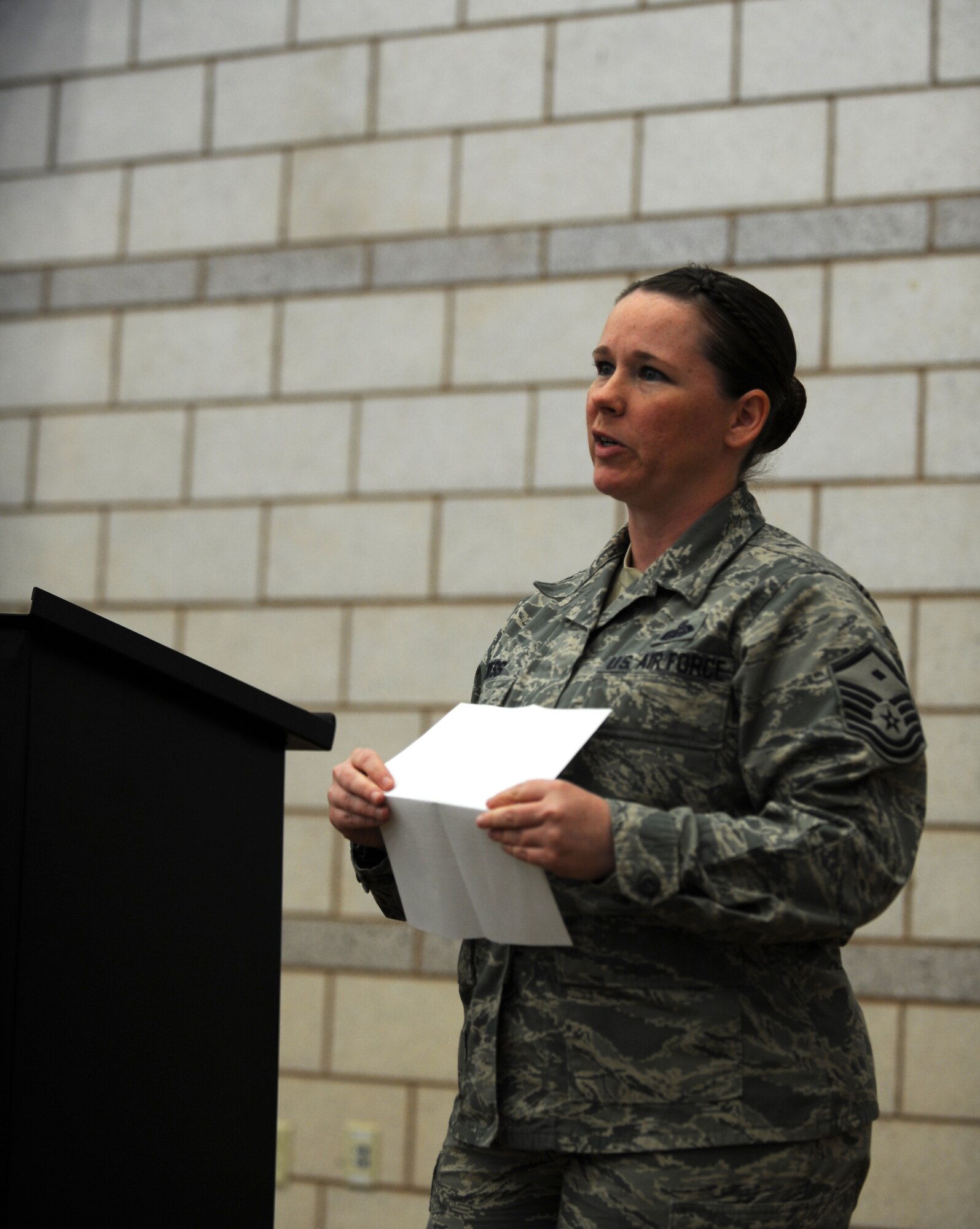U.S. Air Force Master Sgt. Brandy Wess, 7th Operations Group first sergeant, speaks during the Air Force Assistance Fund kick-off luncheon March 3, 2014, at Dyess Air Force Base, Texas. Wess spoke about her experience when the AFAF helped her through a financial and emotional hardship in her life. (U.S. Air Force photo by Airman 1st Class Kedesha Pennant/Released)