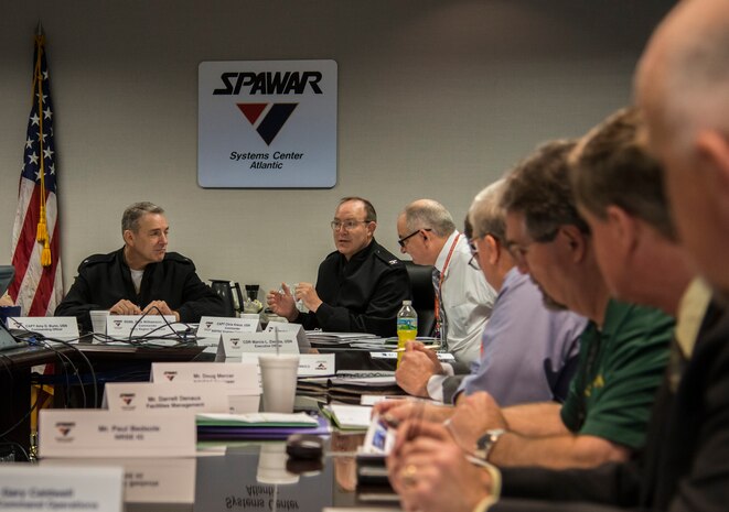 Capt. Chris Kiwus (center), Commander, Naval Facilities Engineering Command Southeast, responds to a question in a meeting March 11, 2014, at the Space and Naval Welfare Systems Center Atlantic on Joint Base Charleston – Weapons Station. S.C. Rear Adm. Rick Williamson, Commander, Navy Region Southeast, recently assumed command of NSRE and made the trip to Charleston, along with members of his staff, to learn about the benefits of joint basing and to chat with Sailors and their leadership. (U.S. Air Force photo/ Airman 1st Class Clayton Cupit)