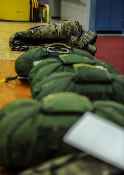 A row of 38th Rescue Squadron aircrew flight equipment bags sit in storage at Moody Air Force Base, Ga., March 11, 2014. On average, the AFE personnel pack roughly 10 parachutes a day. (U.S. Air Force photo by Airman 1st Class Alexis Millican/Released)