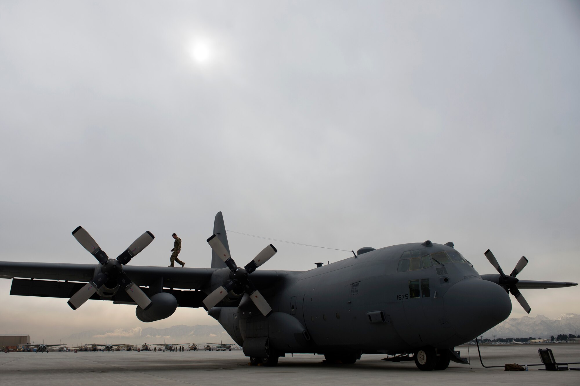 U.S. Air Force Tech. Sgt. Joshua Jay, 438th Air Expeditionary Wing/NATO Air Training Command-Afghanistan flight engineer adviser, completes a pre-flight walk around inspection on an Afghan Air Force C-130 Hercules, before an adviser mission piloted by the AAF, March 10, 2014, Kabul International Airport, Kabul, Afghanistan. Jay, a Peralta, N.M. native, is deployed from the 53rd Airlift Squadron, Little Rock Air Force Base, Ark. Airmen of the 438th AEW/NATC-A play a vital role in Operation Enduring Freedom as advisers tasked with aiding the Afghan government in establishing an operational and sustainable Afghan air force. (U.S. Air Force photo by Tech. Sgt. Jason Robertson/Released)