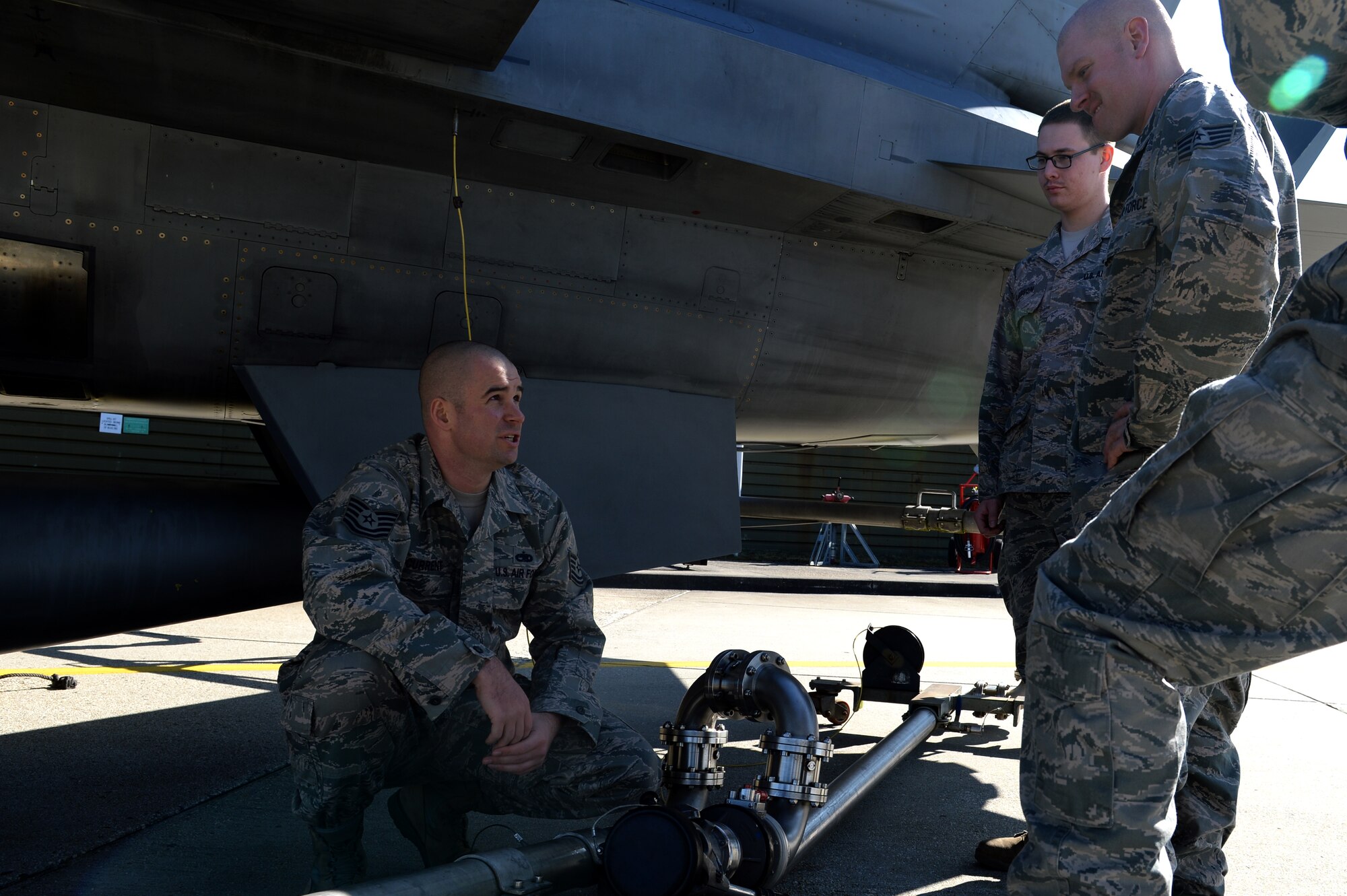 U.S. Air Force Tech. Sgt. Jeff Current, 52nd Maintenance Group maintenance operations F-16 Fighting Falcon fighter aircraft maintenance instructor and NCO in charge of instruction, briefs a class of Airmen responsible for fueling aircraft on hot pits at Spangdahlem Air Base, Germany, March 10, 2014. Hot pits are a procedure that allows aircraft to remain running while being refueled. (U.S. Air Force photo by Senior Airman Alexis Siekert/Released)