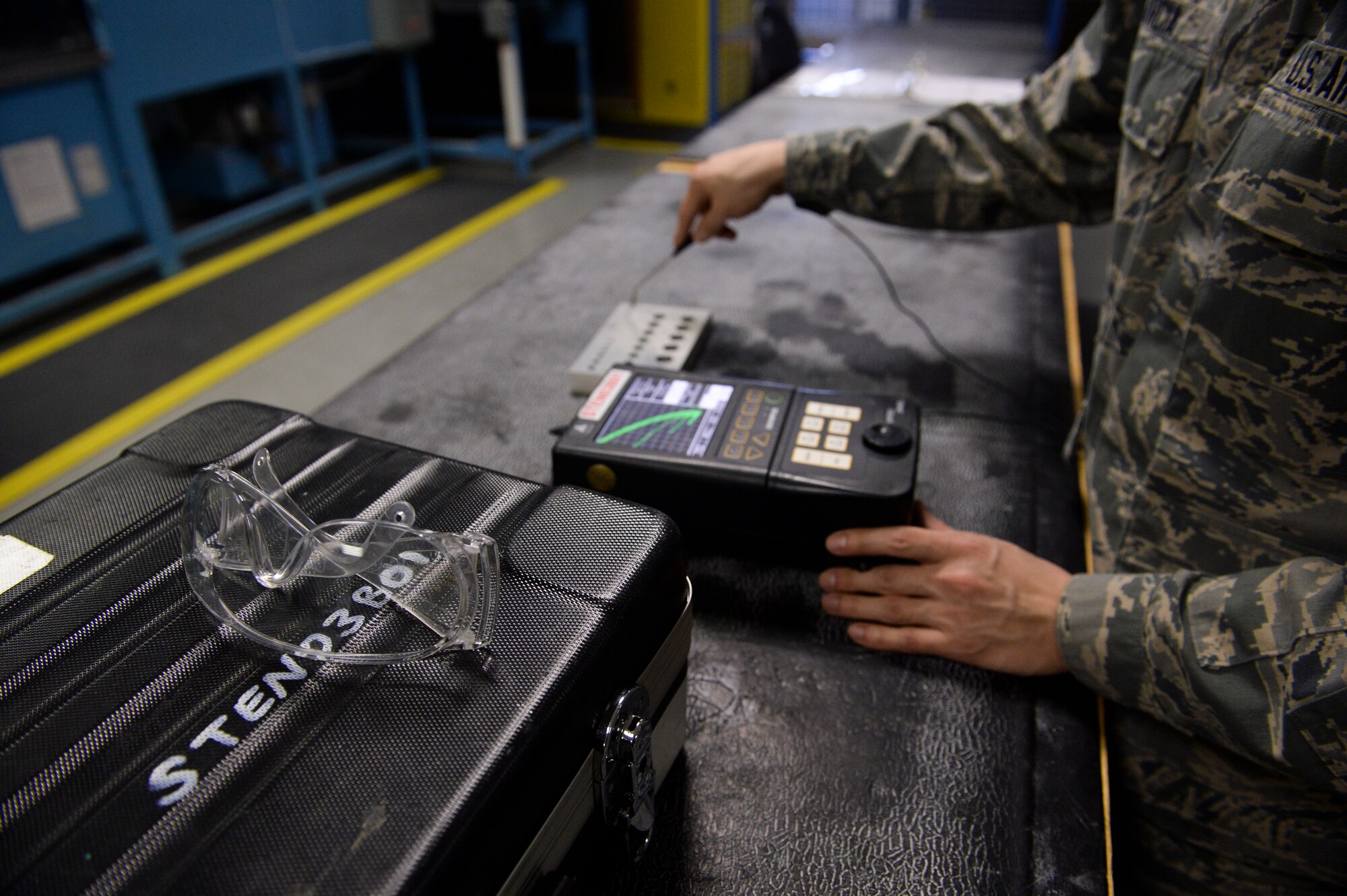 U.S. Air Force Airman 1st Class Christopher Garcia, a 52nd Equipment Maintenance Squadron non- destructive inspection apprentice from Tucson, Ariz., calibrates an Eddie current unit March 7, 2014, at Spangdahlem Air Base, Germany. The Eddie current unit detects small cracks on the aircraft that are too small for the human eye to see. (U.S. Air Force photo by Senior Airman Rusty Frank/Released)