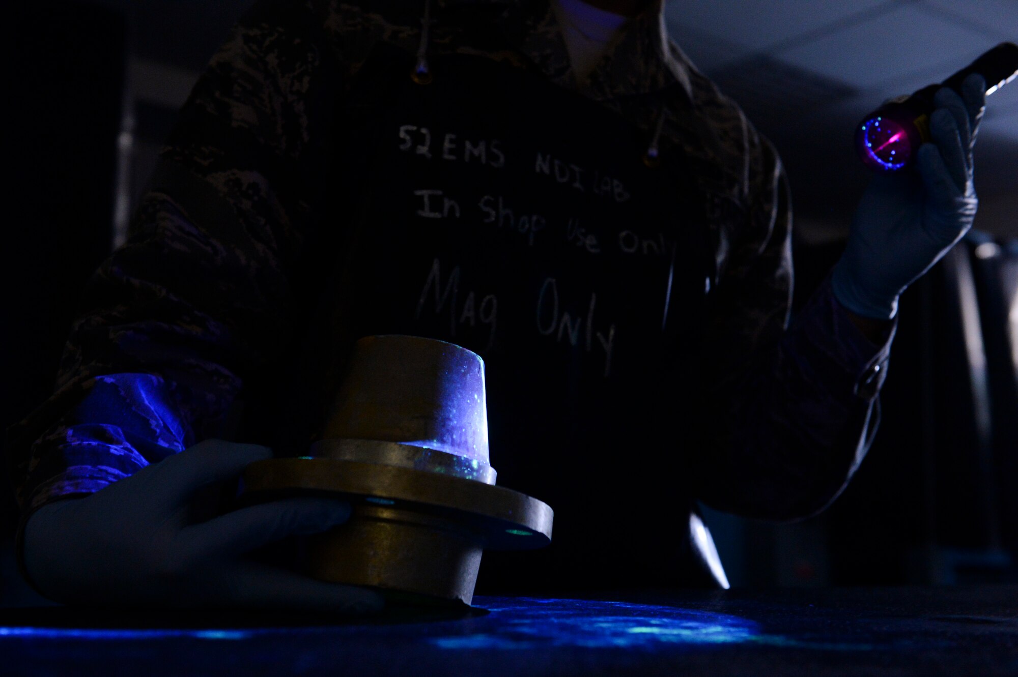 U.S. Air Force Airman 1st Class Christopher Garcia, a 52nd Equipment Maintenance Squadron non-destructive inspection apprentice from Tucson, Ariz., inspects a training part March 7, 2014, at Spangdahlem Air Base, Germany. Airmen of the NDI lab train continuously to stay proficient at detecting small cracks in aircraft parts.  (U.S. Air Force photo by Senior Airman Rusty Frank/Released)