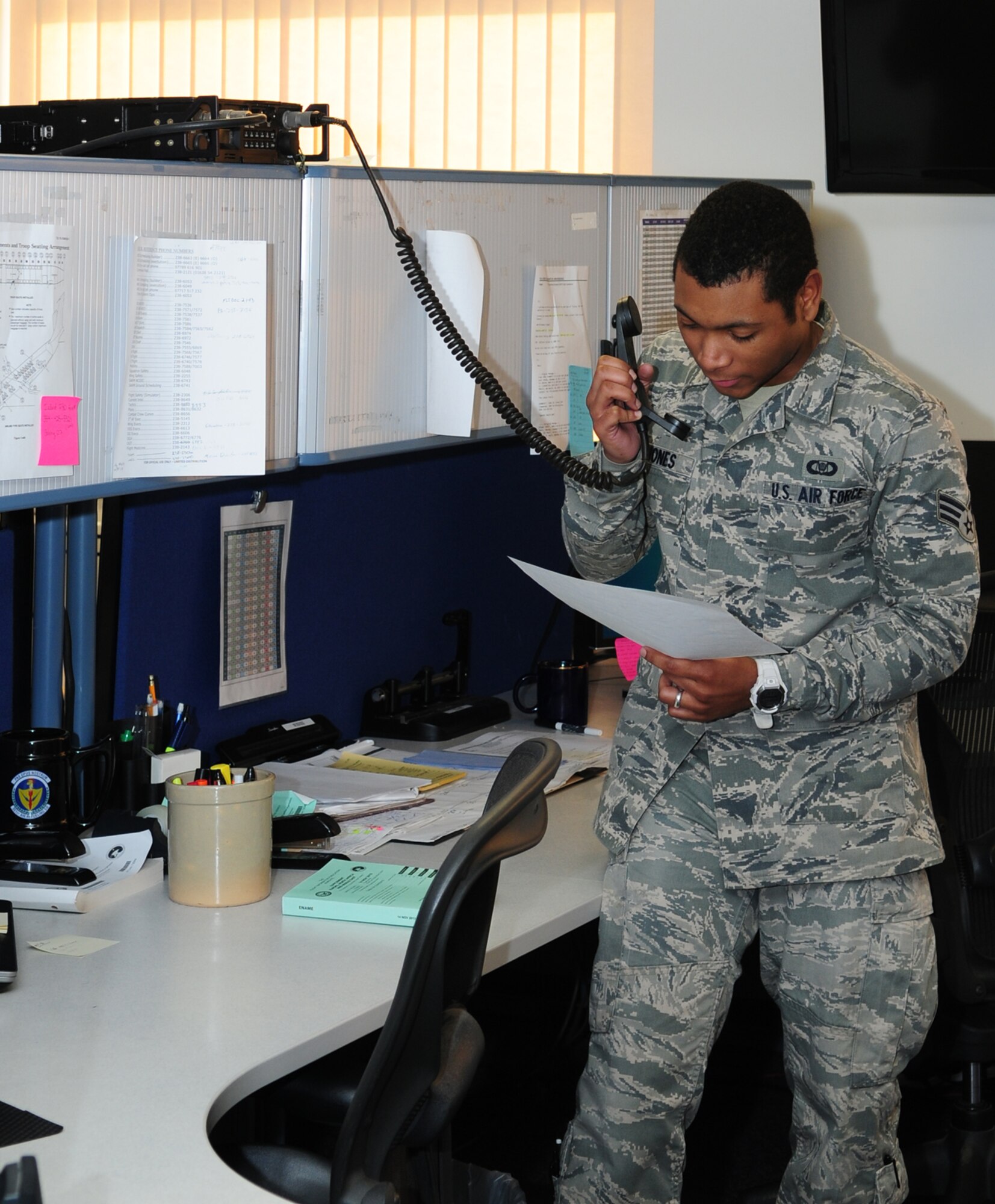 U.S. Air Force Senior Airman Jonathan Quinones, 100th Operations Support Squadron current operations scheduler from Lowell, Mass., coordinates a last-minute mission change with a 100th Air Refueling Wing KC-135 Stratotanker crew Jan. 14, 2014, on RAF Mildenhall, England. The 100th OSS Wing Schedulers are a one-stop shop for RAF Mildenhall, coordinating to ensure the mission happens, aircrew can get where they need to be without problems and the aircraft have the correct amount of fuel required for off-loading. They are also responsible for making sure the receivers are where they need to be at the right time to get refueled. (U.S. Air Force photo by Karen Abeyasekere/Released)