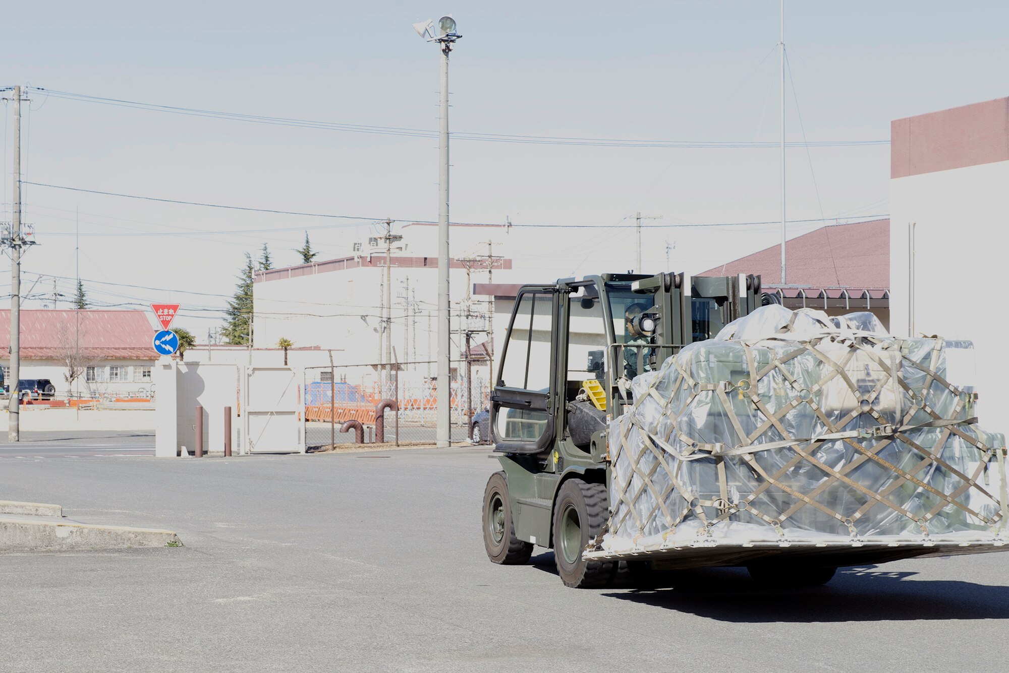 Staff Sgt. Henry Kabiling, 374th Medical Support Squadron non-commissioned officer in charge of storage and distribution, transports a pallet of supplies with a 10k forklift at Yokota Air Base, Japan, March 13, 2014. Members of the Medical Logistics flight are trained in the operation of various power -lifting equipment such as the 10k forklift. (U.S. Air Force photo by Airman 1st Class David Danford/Released)