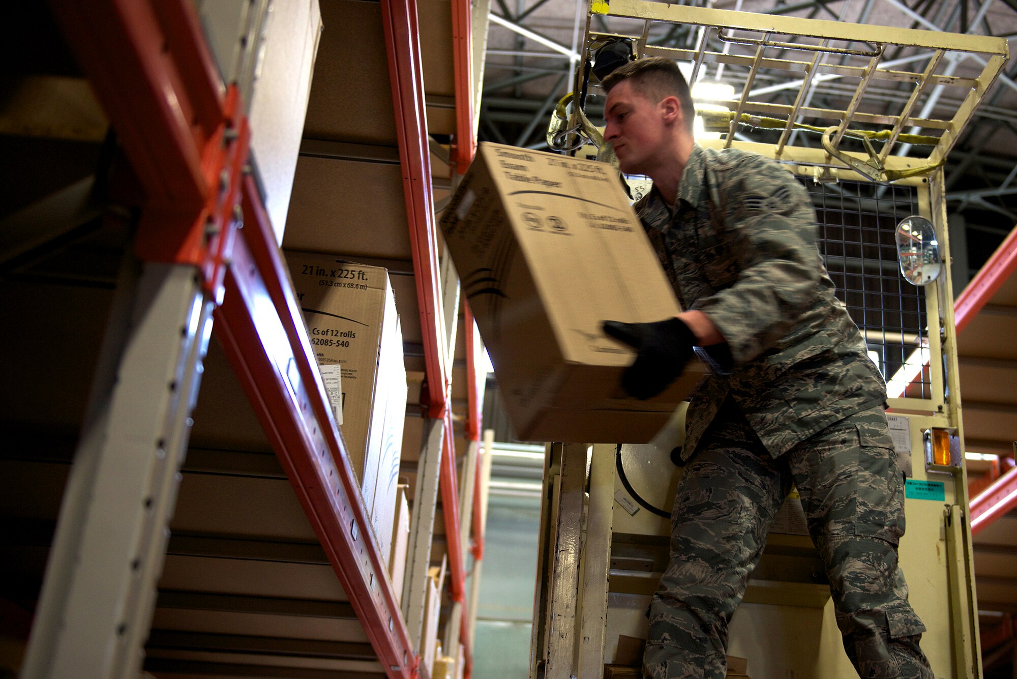 Senior Airman Brandon Caves, 374th Medical Support Squadron purchasing agent, restocks shelves of medical supplies at Yokota Air Base, Japan, March 13, 2014. More than $218k worth of materials are stored in the Yokota Medical Logistics warehouse. (U.S. Air Force photo by Airman 1st Class David Danford/Released)