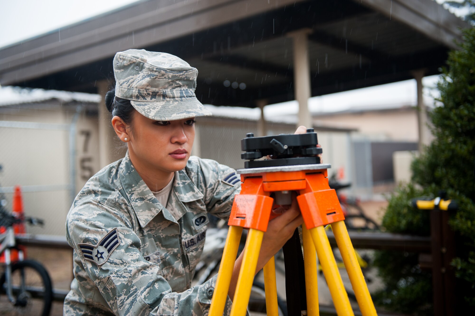 Senior Airman Joyce Tucker, 8th Civil Engineer Squadron engineering technician, sets up a Trimble 5600 Total Station at Kunsan Air Base, Republic of Korea, March 12, 2014. During Women's History Month Kunsan will highlight the "Women of the Wolf Pack." (U.S. Air Force photo by Staff Sgt. Clayton Lenhardt/Released)