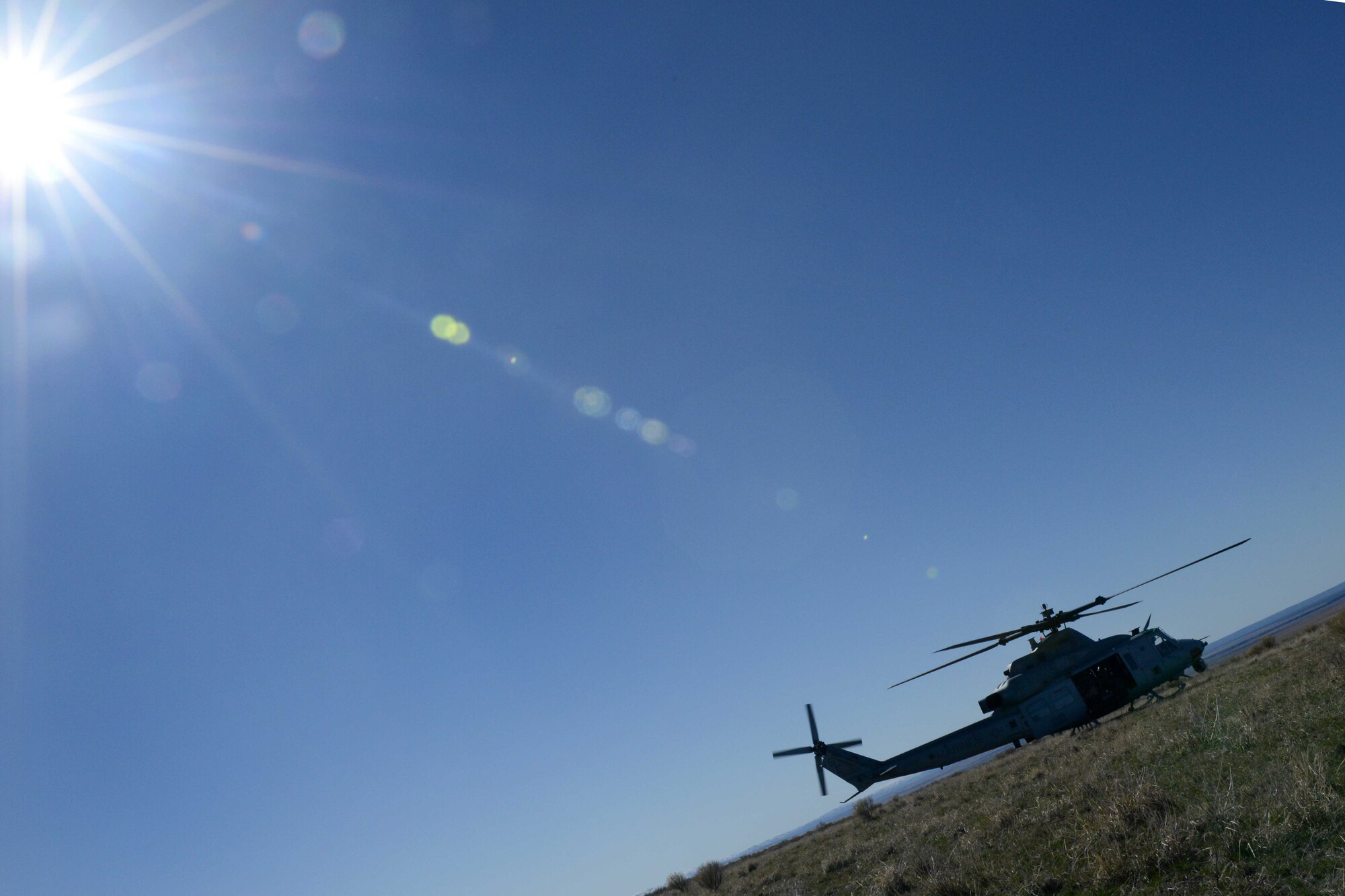 A UH-1Y Venom touches down as it waits for an exfill of combat controllers during Gunfighter Flag, on the Juniper Butte Range at Mountain Home Air Force Base, Idaho, March 13, 2014. The purpose of the exercise is to prepare for upcoming deployments as well as provide proficiency training for aircrews. (U.S. Air Force photo by Senior Airman Caitlin Guinazu/RELEASED) 
