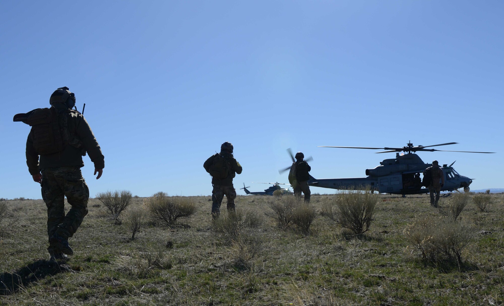 Combat Controllers load onto a UH-1Y Venom during Gunfighter Flag on the Juniper Butte Range at Mountain Home Air Force Base, Idaho, March 13, 2014. During the training military aircraft and personnel from the U.S. Air Force, U.S. Marine Corps, Navy and the British Army will perform exercise combat operations. (U.S. Air Force photo by Senior Airman Caitlin Guinazu/RELEASED)  