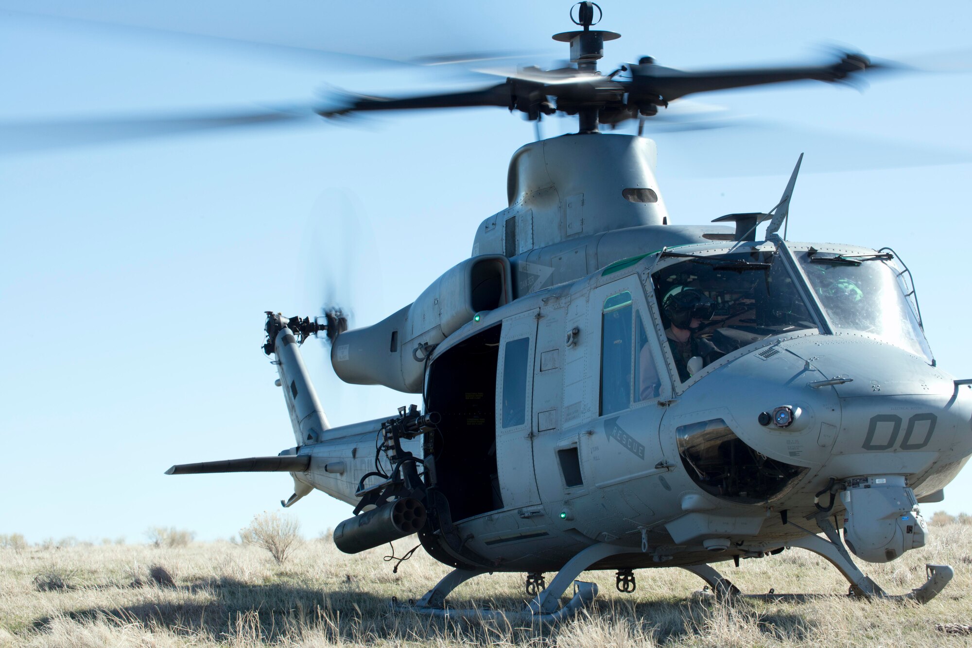 A UH-1Y Venom awaits the load of Air Force combat controllers at Juniper Butte Range, Mountain Home Air Force Base, Idaho, March 12, 2014. The Marine Corps works alongside the Air Force as a large-scale joint exercise. (U.S. Air Force Photo by Airman 1st Class Malissa Lott/RELEASED)