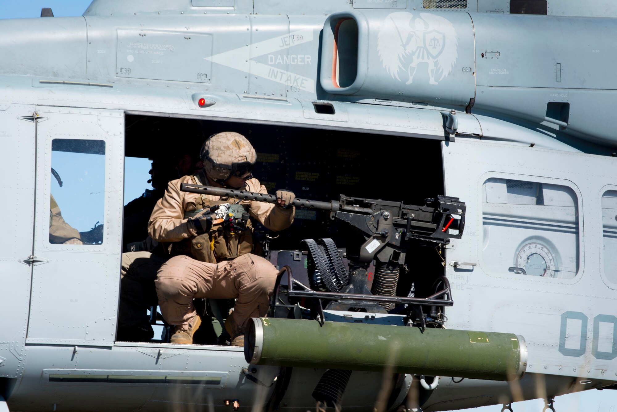 A Marine UH-1Y Venom gunner scans the horizon after the exfill of Air Force combat controllers at Juniper Butte Range, Mountain Home Air Force Base, Idaho, March 12, 2014. Working with joint partners provides preparation for real-time deployments. (U.S. Air Force Photo by Airman 1st Class Malissa Lott/RELEASED)