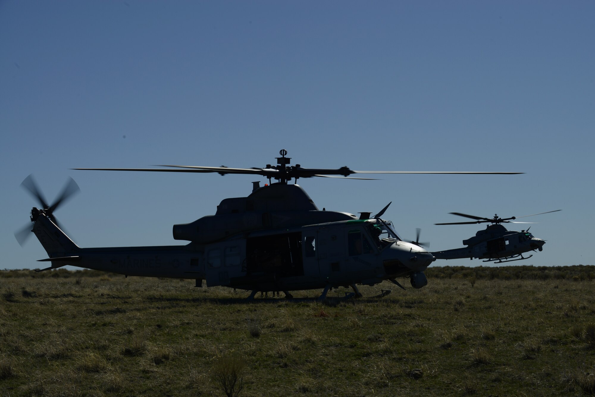 Two United States Marine Corps UH-1Y Venom helicopters participating in Gunfighter Flag land March 12, 2014, at the Juniper Butte Bombing Range near Mountain Home Air Force Base, Idaho. Operations out of MHAFB will be increased throughout the week of March 10-14 due to the combat exercise. Gunfighter Flag is an excellent opportunity for aircrew members from multiple squadrons to train and respond to multiple daily launches. (U.S. Air Force photo by Senior Airman Benjamin Sutton/Released) 