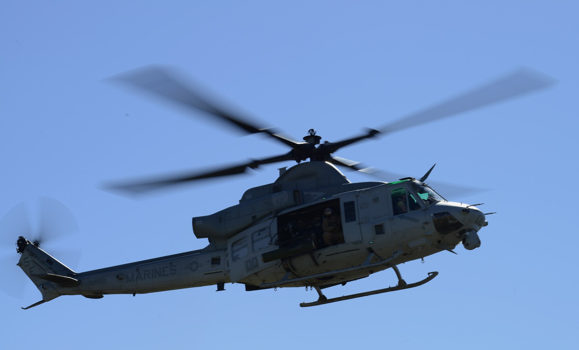 A United States Marine Corps UH-1Y Venom helicopter participating in Gunfighter Flag hovers to a landing point March 12, 2014, at the Juniper Butte Bombing Range near Mountain Home Air Force Base, Idaho. Operations out of MHAFB will be increased throughout the week of March 10-14. Gunfighter Flag is an excellent opportunity for ground crew members to train and respond to multiple daily launches. (U.S. Air Force photo by Senior Airman Ben Sutton/Released) 
