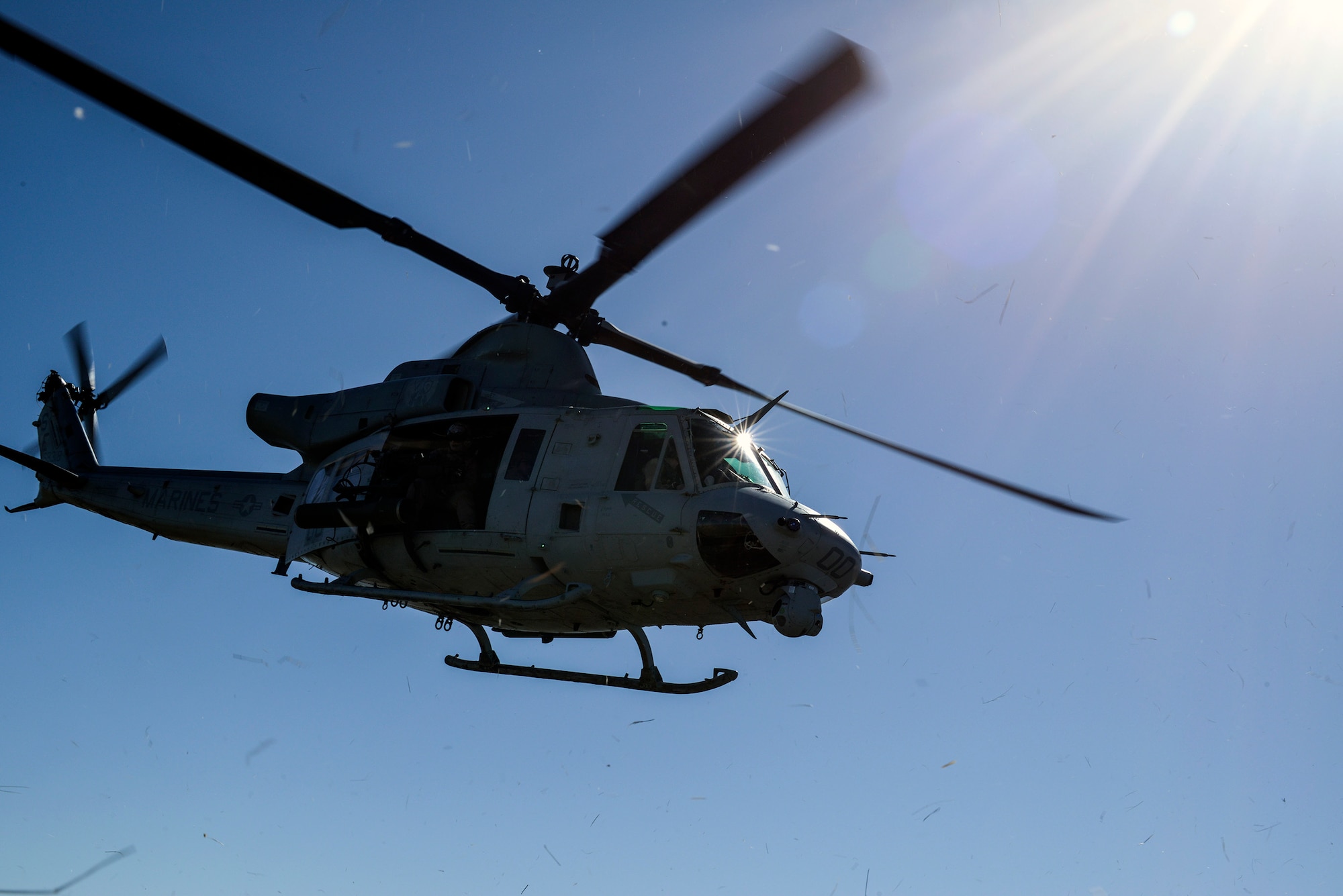 A U.S. Marine Corps UH-1 Huey takes off with a team of Air Force combat controllers, who were controlling close-air support training missions at Juniper Butte Range, Mountain Home Air Force Base, Idaho, March 12, 2014. Mountain Home Air Force Base and the 266th Range Squadron controls and maintains emitter sites across almost 7,500-square miles of operational range space, and it’s that access to airspace and ranges that allows for realistic, safe training and testing while providing the flexibility to accommodate the complexity of this multinational, multiservice exercise. (U.S. Air Force photo by Master Sgt. Kevin Wallace/RELEASED)