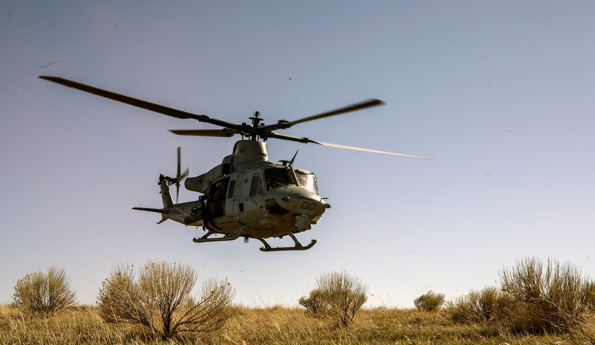 A U.S. Marine Corps UH-1 Huey takes off with a team of Air Force combat controllers, who were controlling close-air support training missions at Juniper Butte Range, Mountain Home Air Force Base, Idaho, March 12, 2014. The CCT team was one part of the exercise, which consisted of all three MHAFB fighter squadrons, more than 300 visiting Marines and British partners. (U.S. Air Force photo by Master Sgt. Kevin Wallace/RELEASED)