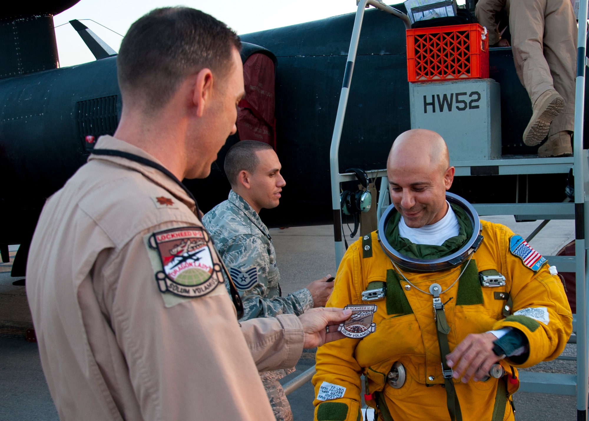 Air Force Maj. Ralph Shoukry, a pilot and tactics and employment lead assigned to the 99th Expeditionary Reconnaissance Squadron, is presented a patch after completing more than 1,000 combat flying hours at an undisclosed location in Southwest Asia, March 6, 2014. (U.S. Air Force photo by Staff Sgt. Michael Means/Released)