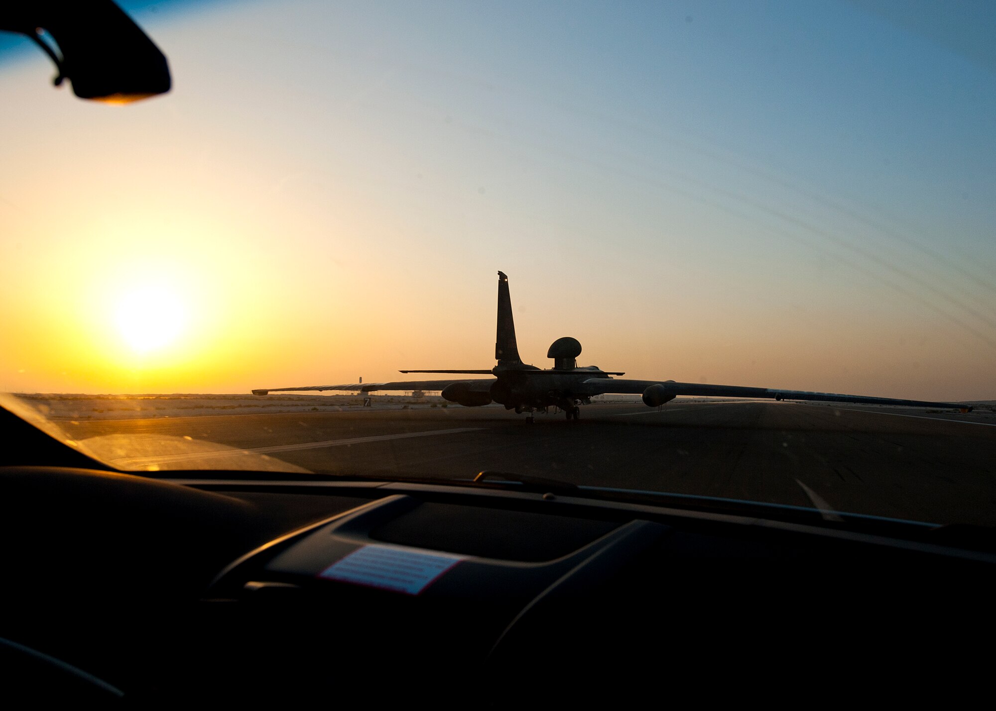 A chase car follows behind a U-2 Dragonlady after guiding it in for landing at an undisclosed location in Southwest Asia, March 6, 2014. The aircraft was flown by Air Force Maj. Ralph Shoukry, a pilot and tactics and employment lead assigned to the 99th Expeditionary Reconnaissancee Squadron, after reaching more than 1,000 combat flying hours. (U.S. Air Force photo by Staff Sgt. Michael Means/Released)