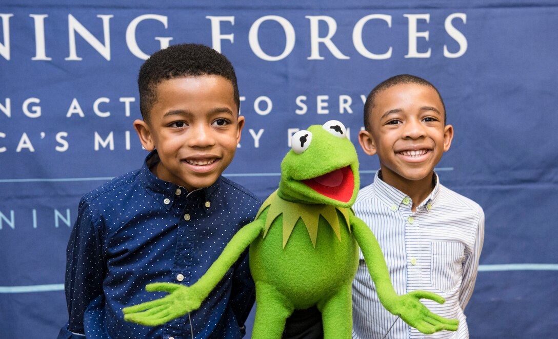 Children pose for a photo with Kermit the Frog during an event to screen the new Muppets movie, "Muppets Most Wanted," at the White House, March 12, 2014. 