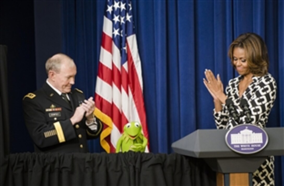 Army Gen. Martin E. Dempsey, chairman of the Joint Chiefs of Staff, and First Lady Michelle Obama applaud Kermit the Frog as they welcome military families to a screening of the new Muppets movie, "Muppets Most Wanted," at the White House, March 12, 2014. The trio thanked military families for their service, strength and resiliency. 