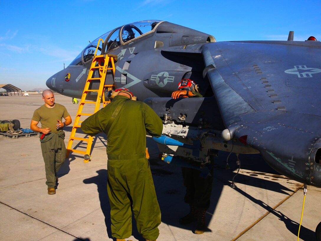 Marines from Marine Attack Squadron 203, help disarm aircraft on the flight line of Marine Corps Air Station Yuma, Ariz., Tues. VMAT-203’s main objective at MCAS Yuma is to train new winged pilots to fly the AV-8B Harrier.


