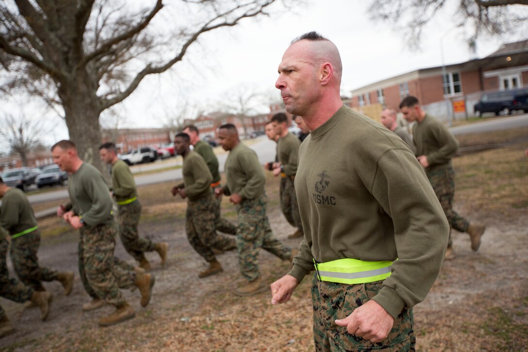 U.S. Marine Corps Sgt. Maj. Todd M. Parisi, 26th Marine Expeditionary Unit (MEU) sergeant major, runs beside the Marines assigned to 26th MEU Command Element (CE) as they conduct a formation run led by the unit’s non-commissioned officers (NCOs), aboard Camp Lejeune, N.C., Feb. 26, 2014. The physical training was conducted to foster unit cohesion and give NCOs the opportunity to coordinate and run a unit level event. (U.S. Marine Corps photo by Sgt. Christopher Q. Stone, 26th MEU Combat Camera/Released) 