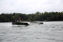 Marines with Bridge Company, 8th Engineer Support Battalion, 2nd Marine Logistics Group steer an Improved Ribbon Bridge with an MK III Bridge Erection Boat near Camp Lejeune, N.C., the company used similar ships to transport personnel to base ranges March 10, 2014. The company crossed the New River to rifle ranges as part of an annual training exercise meant to enhance the combat efficiency. (U.S. Marine Corps photo by Lance Cpl. Shawn Valosin)