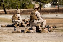 Staff Sgt. Scottie McDaniel (right), a Burlington, N.C., native and  a combat marksmanship trainer with Bridge Company, 8th Engineer Support Battalion, 2nd Marine Logistics Group,  and Cpl. Tyler Comar (left), a Hillsborough, N.C., native, supervise Marines during the table three and four portions of the combat marksmanship program aboard Camp Lejeune, N.C., March 10, 2014. Marines with the company fired more than 7,000 rounds during day and night shoots.  (U.S. Marine Corps photo by Lance Cpl. Shawn Valosin)
