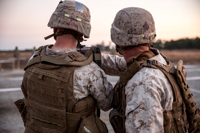 Cpl. Tyler Comar (right), a Hillsborough, N.C., native and a combat marksmanship trainer with Bridge Company, 8th Engineer Support Battalion, 2nd Marine Logistics Group, instructs a Marine during the table three portion of the combat marksmanship program aboard Camp Lejeune, N.C., March 10, 2014. Marines with the company fired more than 7,000 rounds during day and night shoots. (U.S. Marine Corps photo by Lance Cpl. Shawn Valosin)