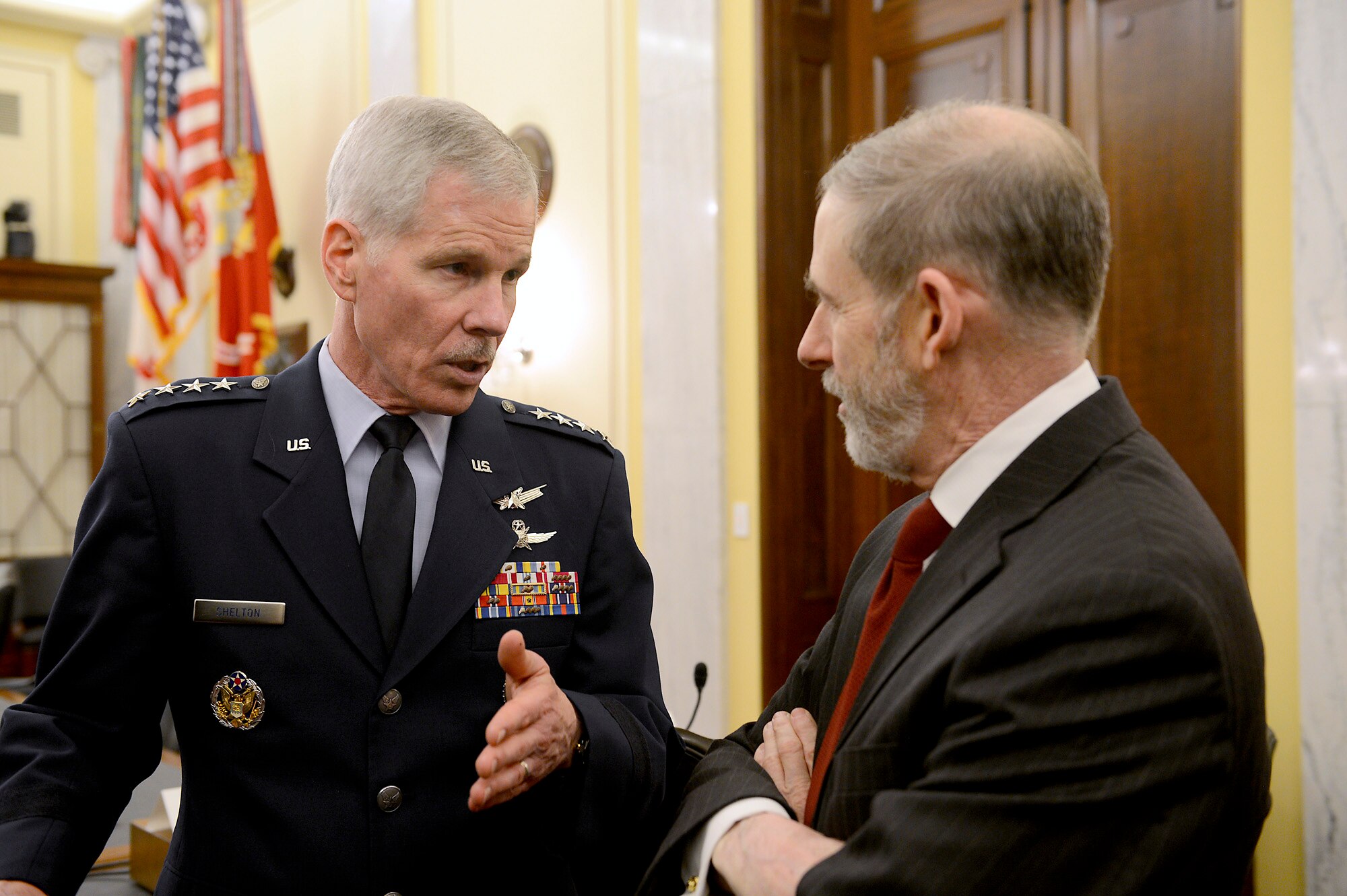 General William L. Shelton talks with Douglas L. Loverro before they testified in front of the U.S. Senate Committee on Armed Services’ Subcommittee on Strategic Forces March 12, 2014, in Washington, D.C.  Shelton and Loverro testified on military space programs in review of the defense authorization request for fiscal. Shelton is the commander of Air Force Space Command and Loverro is the deputy assistant secretary of defense for space policy.  (U.S. Air Force photo/Scott M. Ash)