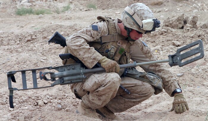 During Operation Enduring Freedom in Afghanistan, a Marine probes an area after his Ground Penetrating Radar Metal Detector set off an alarm. Counter-improvised explosive device systems such as this are under scrutiny by the C-IED War Room at Marine Corps Systems Command at Quantico, Va.