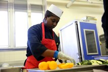 Sgt. Tannisha Gamble, a Jacksonville, Fla. native and food service specialist with Food Service Company, Combat Logistics Regiment 27, 2nd Marine Logistics Group, cuts lemons at the chef of the quarter competition aboard Marine Corps Base Camp Lejeune, N.C., March 11, 2014. Each team’s score was based on cooking fundamentals, composition of dish, overall flavor, seasoning, timing of service and temperature. 