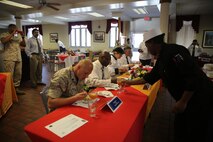 Sgt. Tannisha Gamble (right), a Jacksonville, Fla. native and food service specialist with Food Service Company, Combat Logistics Regiment 27, 2nd Marine Logistics Group, serves a warm and spicy punch to judges during the chef of the quarter competition aboard Marine Corps Base Camp Lejeune, N.C., March 11, 2014. Gamble and Pfc. Jordan Agosto, a Brooklyn, N.Y. native and food service specialist with the company, both won a medal and chef jacket with their names embroidered on it. 