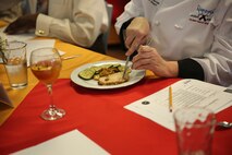 A judge cuts into a piece of Autumn pork roast during the chef of the quarter competition aboard Marine Corps Base Camp Lejeune, N.C., March 11, 2014. Sgt. Tannisha Gamble, a Jacksonville, Fla. native and Pfc. Jordan Agosto, a Brooklyn, N.Y. native, both food service specialists with Food Service Company, Combat Logistics Regiment 27, 2nd Marine Logistics Group, won the competition.