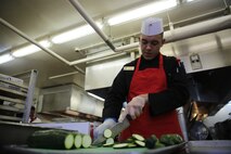 Pfc. Jordan Agosto, a Brooklyn, N.Y. native and food service specialist with Food Service Company, Combat Logistics Regiment 27, 2nd Marine Logistics Group, cuts cucumbers at the chef of the quarter competition aboard Camp Lejeune, N.C., March 11, 2014. This chef of the quarter competition was created around the theme “Autumn Begins.” 