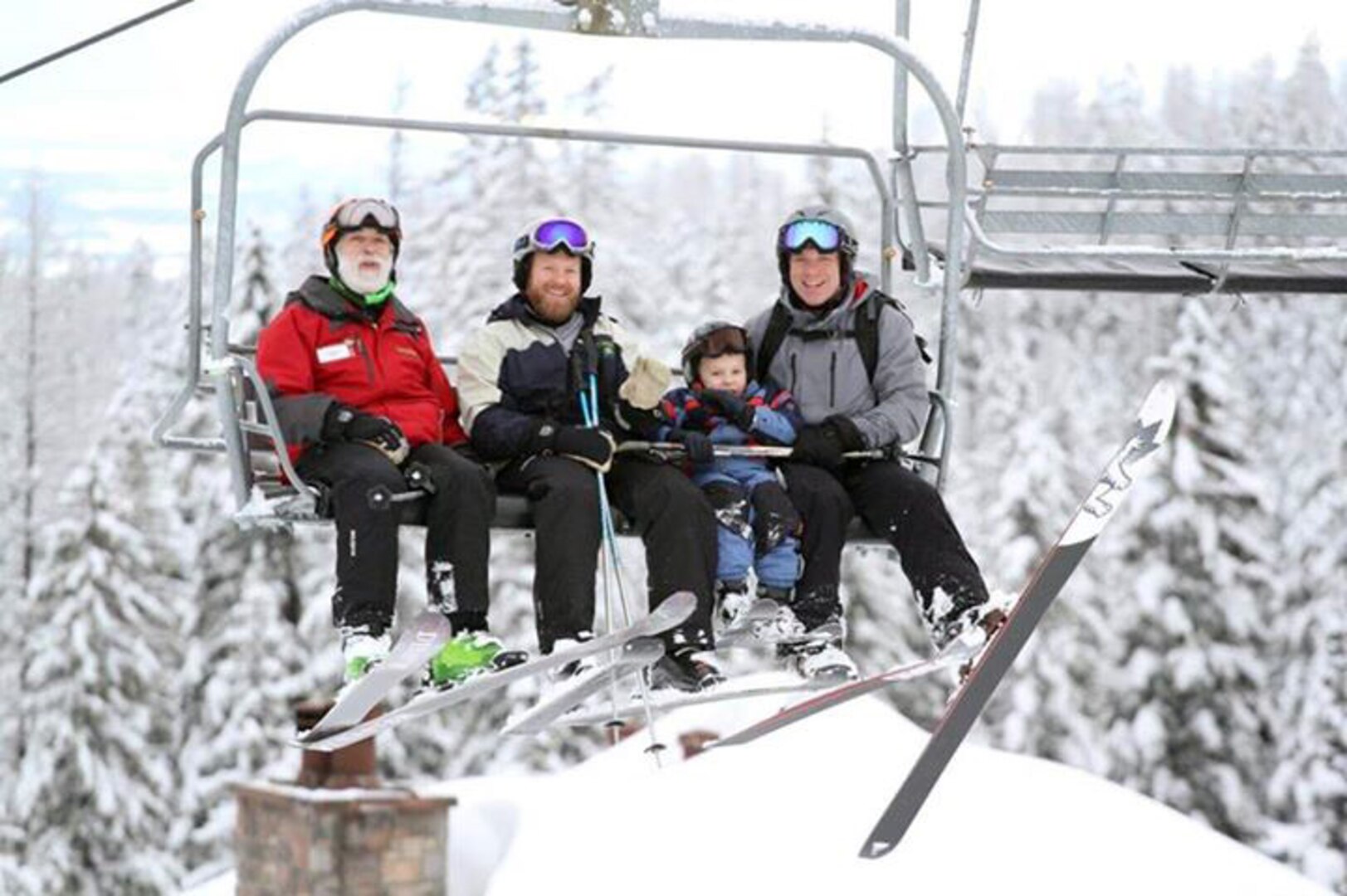 Volunteers from Whitefish Mountain Resort join Kenny Walker,
second from the left and youngest son Kelson on the chairlift at the
Whitefish Mountain Resort in January