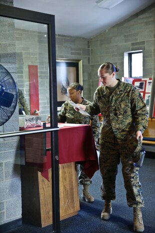 Marines from Marine Corps Air Station Cherry Point, Marine Corps Base Camp Lejeune and Marine Corps Air Station New River filter into the chapel for the third annual Vivian A. Holmes Female Marine Symposium, Feb. 25. (U.S. Marine Corps photo by Cpl. Mary M. Carmona/Released.)