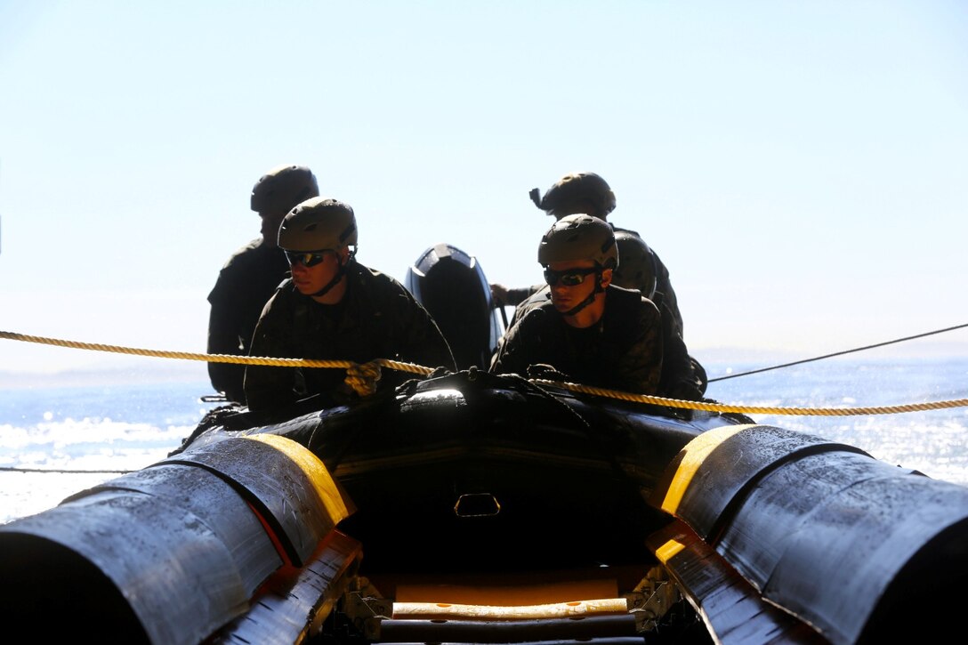 Marines with Bravo Company, 1st Reconnaissance Battalion, prepare to launch a zodiac from the USS Freedom during on and off loading drills three miles off the coast of Del Mar beach Marine Corps Base Camp Pendleton, Calif., March 10, 2014. The purpose of the training was to find out if the Marines could launch and recover a zodiac, a small inflatable boat with a hand steered engine, onto a littoral combat ship. They discovered that using the LCS gave them the ability to insert and recover reconnaissance teams from a greater distance out at sea.